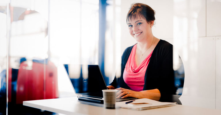 Woman sitting at a desk smiling